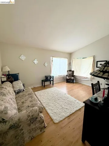 Living area featuring wood finished floors and lofted ceiling