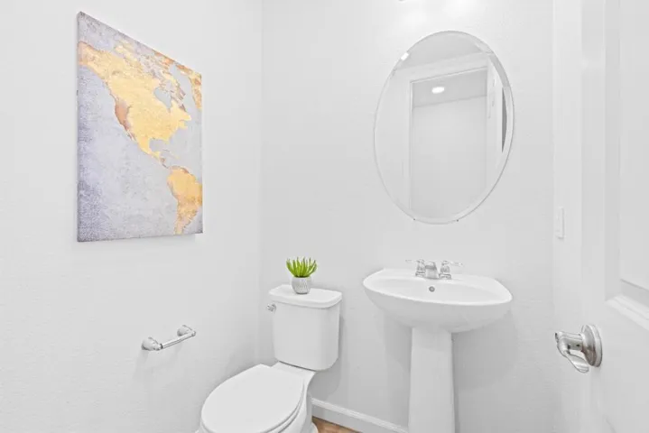 Main-level half bath with potential for future expansion (buyer to verify)