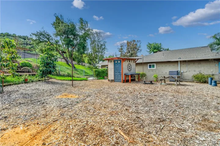 Side of home with outhouse