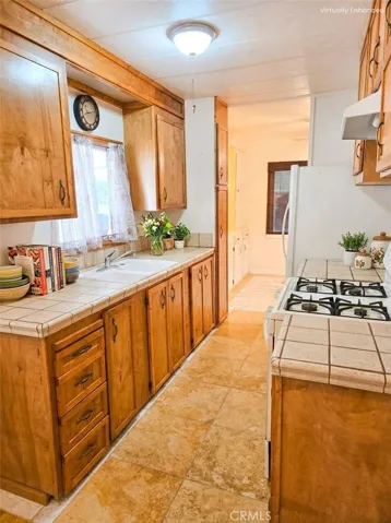 View from laundry area into kitchen. Image has been digitally staged.