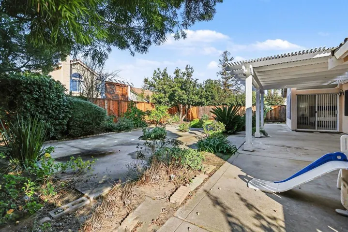 Fenced backyard featuring a pergola and a patio area