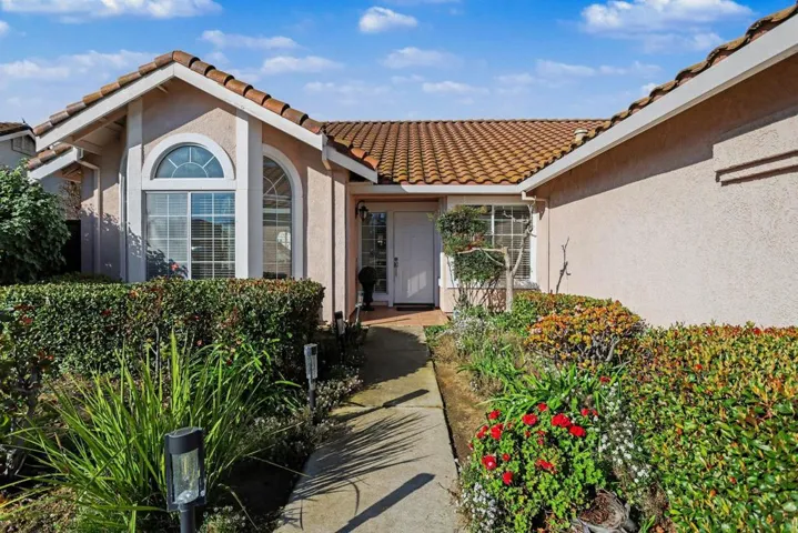 Entrance to property with stucco siding and a tiled roof