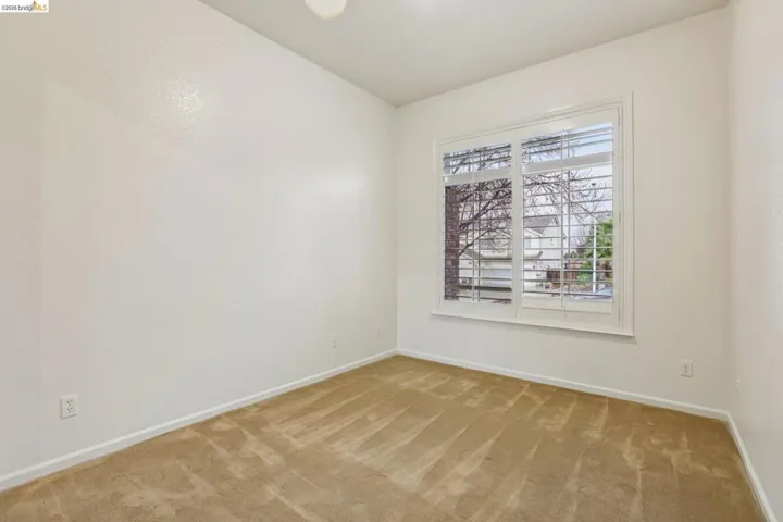Carpeted empty room with baseboards