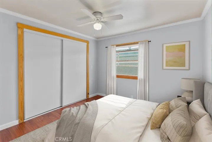 Primary bedroom with wood flooring