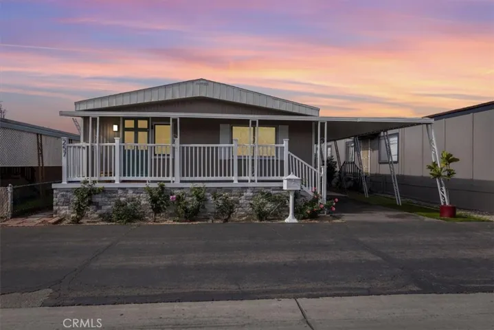 Updated Mfg home with porch & carport