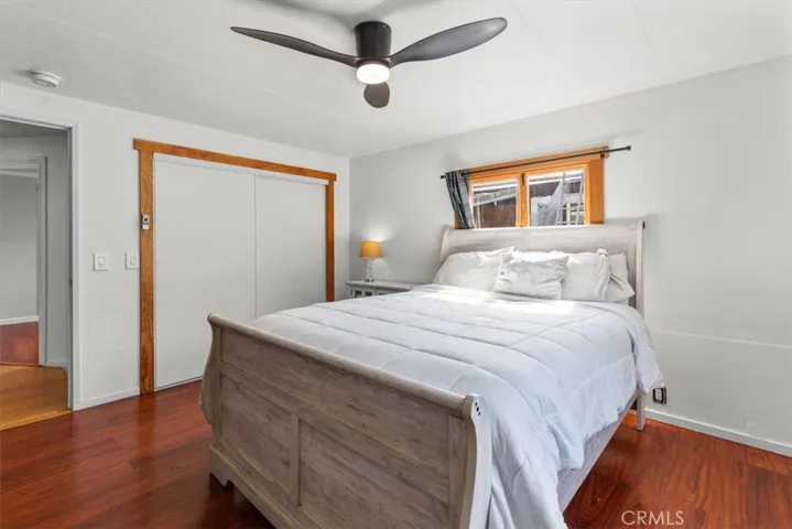 Bedroom with ceiling fan and closet
