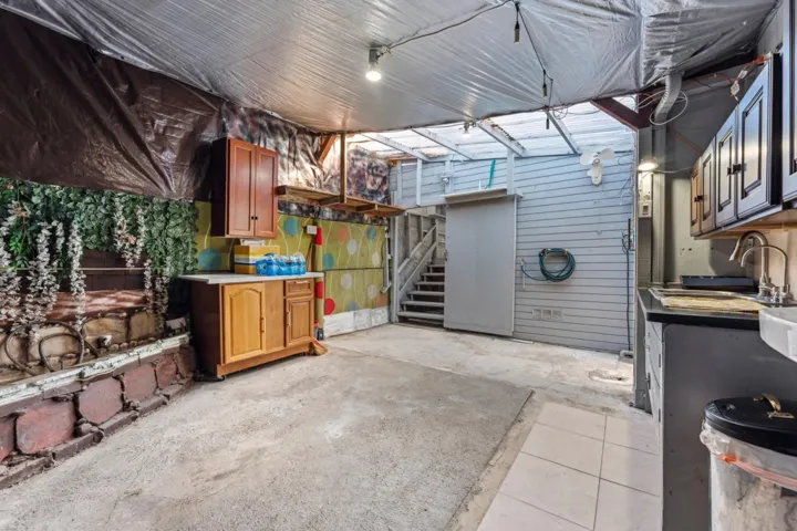 View of patio featuring a sink and stairs