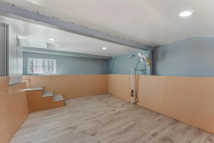 Empty room featuring wood finished floors and recessed lighting