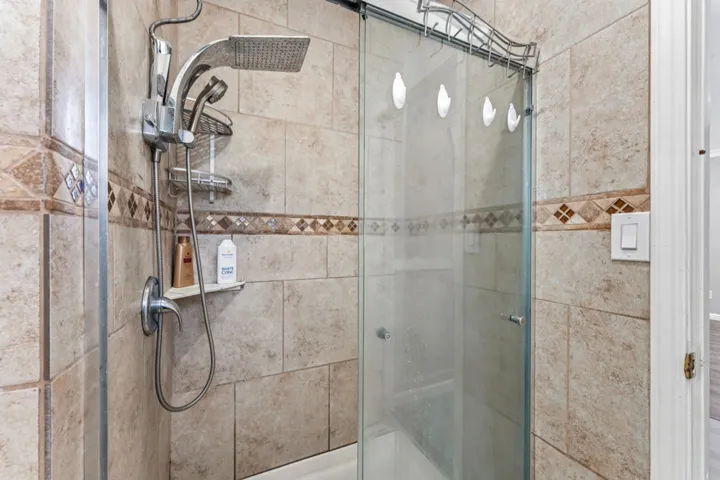 Full bath featuring a shower stall