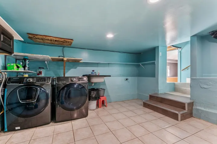 Laundry area with recessed lighting and washing machine and clothes dryer