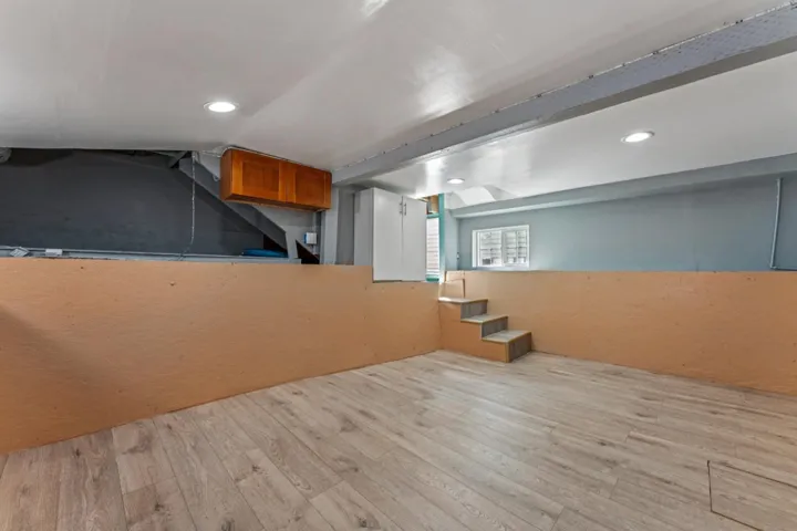Bar area with wood finished floors, recessed lighting, and wood finish cabinets