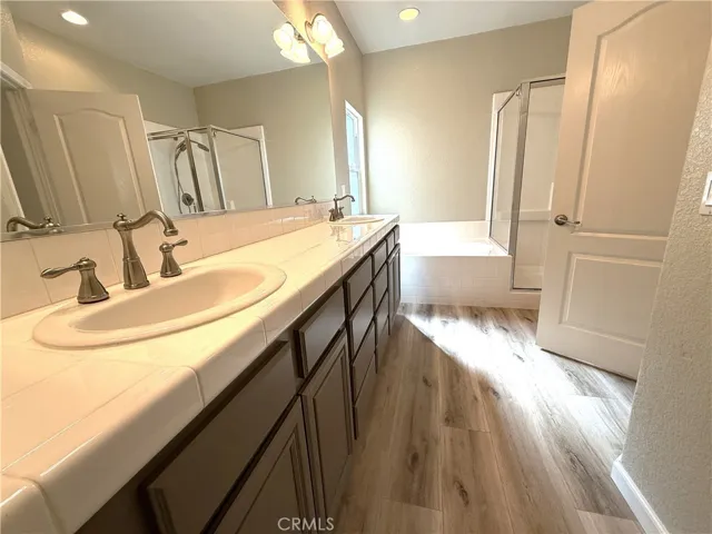 primary bedroom ensuite bath with dual sinks