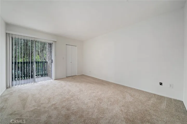 Primary Bedroom with private balcony, walk-in closet and en-suite bathroom