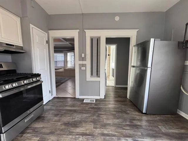 Kitchen featuring stainless steel appliances and dark wood-style floors