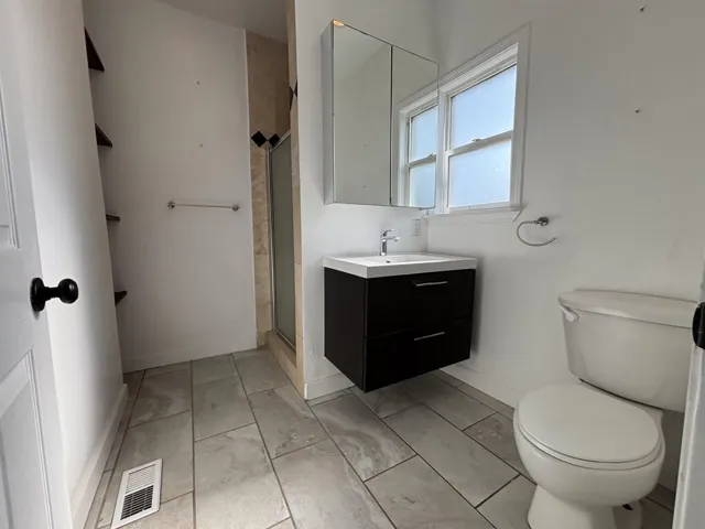 Full bath featuring vanity and a stall shower