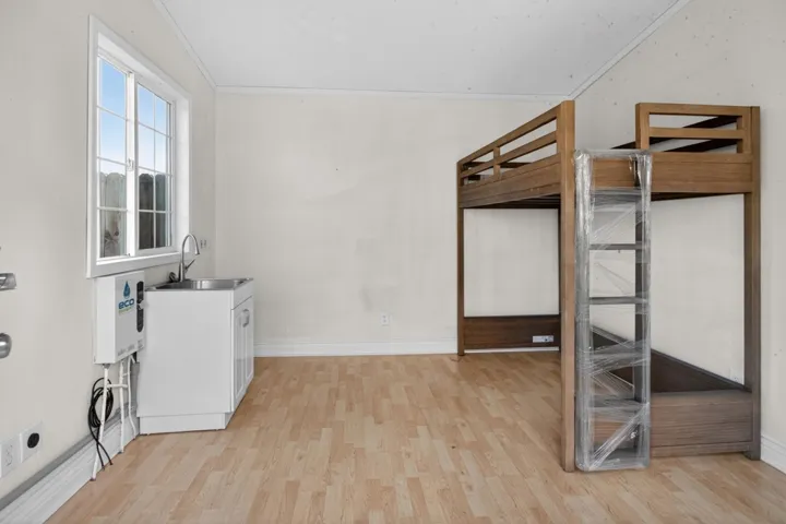 Laundry room with light wood-style flooring and baseboards