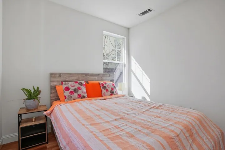 Bedroom featuring wood finished floors and baseboards
