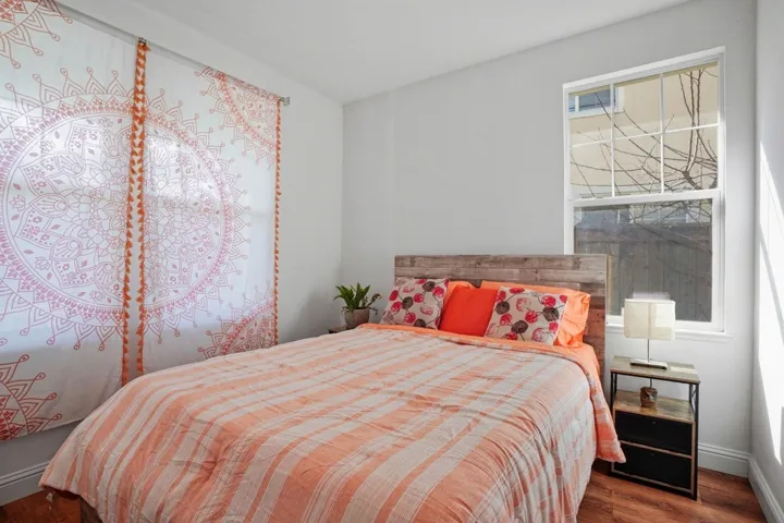 Bedroom with wood finished floors and baseboards