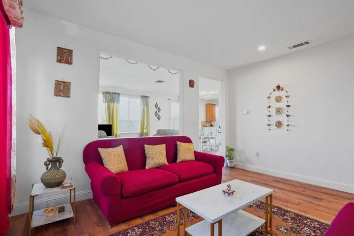 Living room with wood finished floors and recessed lighting