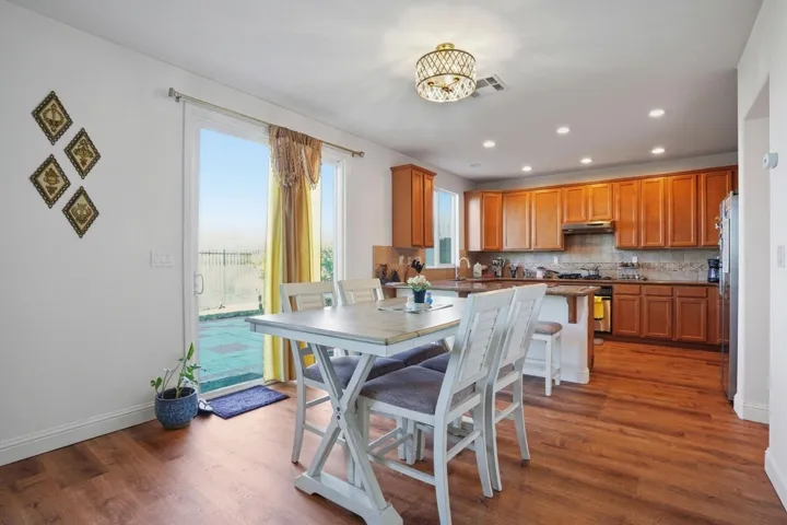 Dining area with dark wood finished floors and a chandelier