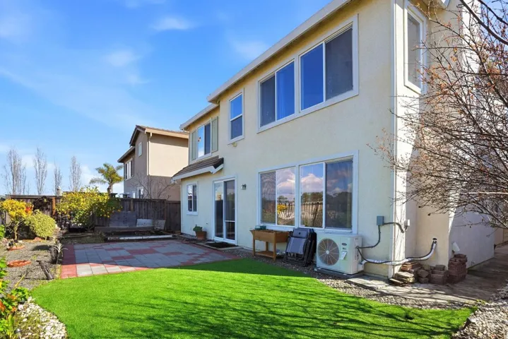 Back of property featuring a patio area, a fenced backyard, and stucco siding