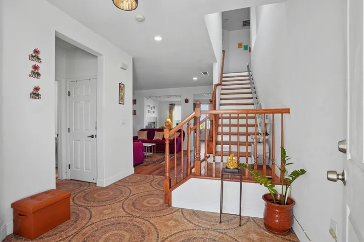 Foyer featuring stairway and recessed lighting