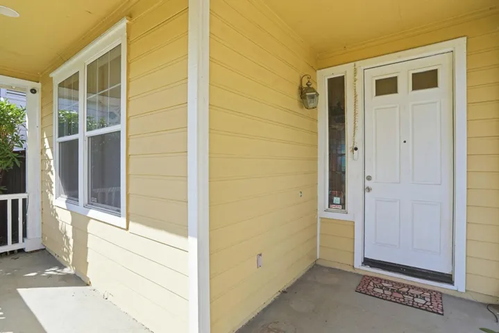 Entrance to property featuring covered porch