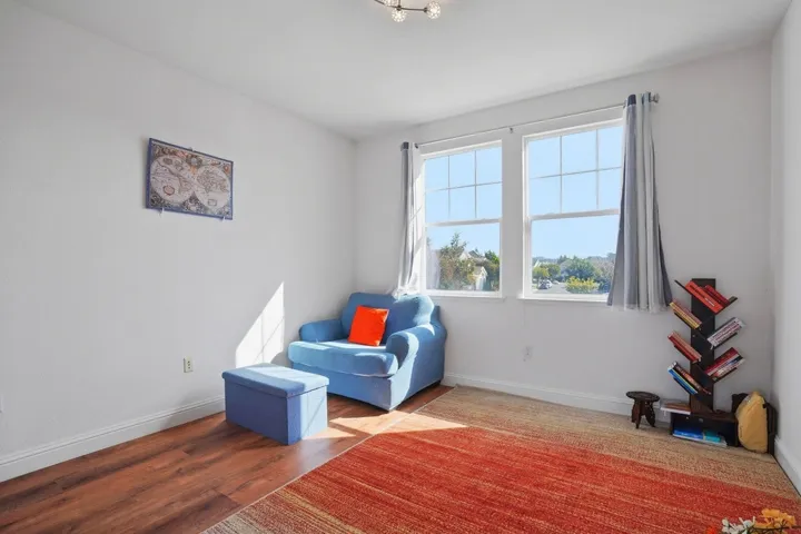 Living area with baseboards and wood finished floors