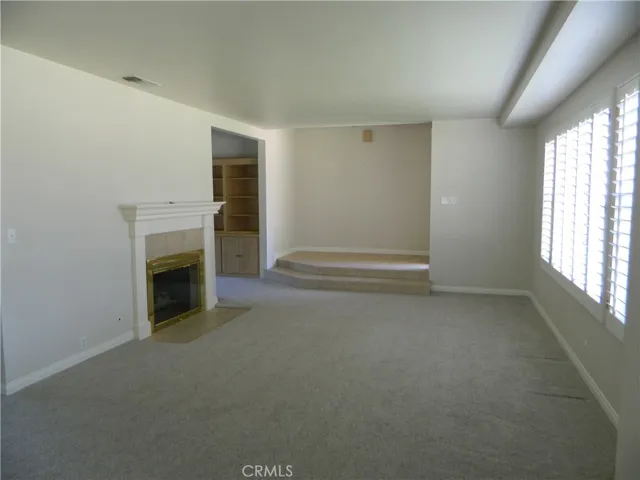 Large Entry and Sunlit Living Room with Fireplace