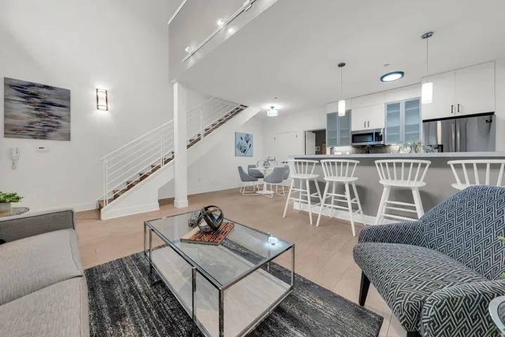 living area featuring light wood finished floors and rail lighting
