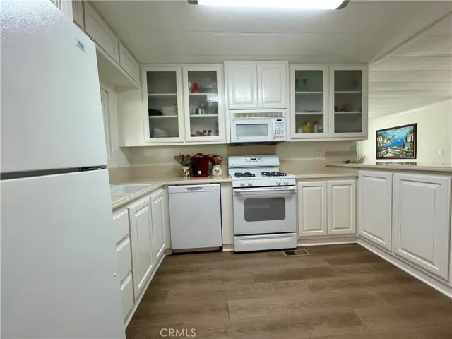 UPDATED FLOORING AND KITCHEN. FRIDGE STAYS!