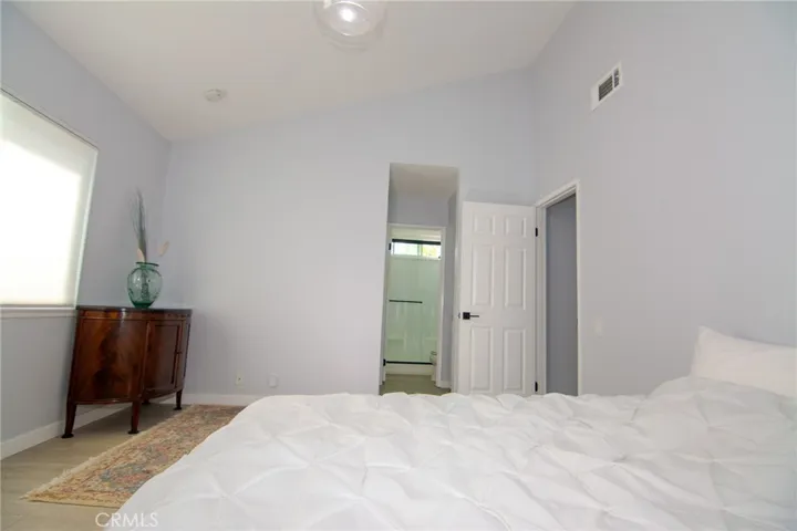 Expansive primary suite highlighted by dramatic vaulted ceilings.