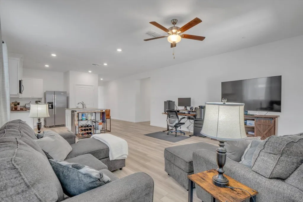 living room featuring an office area, light wood finished floors, recessed lighting, and ceiling fan