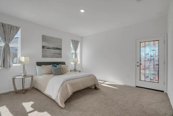 carpeted bedroom featuring baseboards and recessed lighting