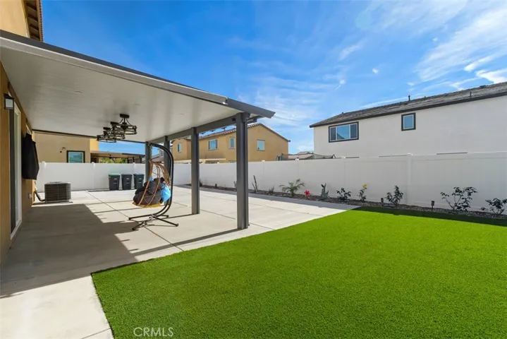 Sizable backyard with tuff and covered patio