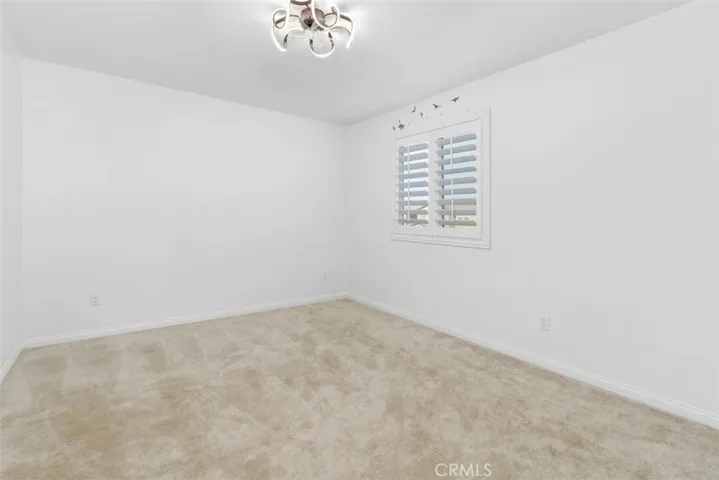secondary bedroom with a walk-in closet