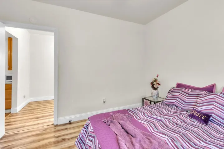 Bedroom featuring baseboards and light wood-type flooring