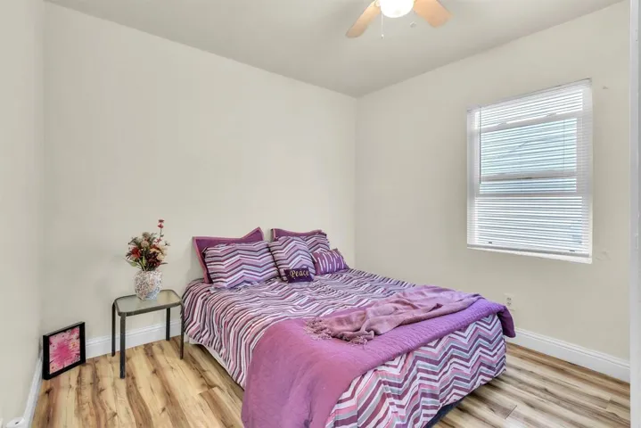 Bedroom with light wood-type flooring and a ceiling fan