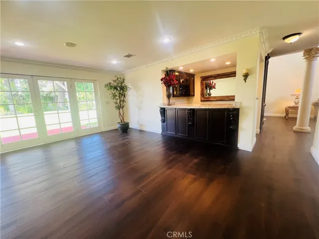 Family room with French doors that gives a bright and airy feeling while facing the backyard.