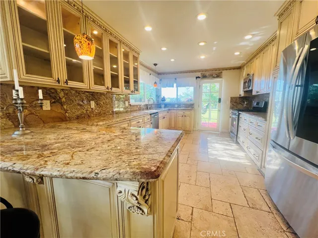 Kitchen, breakfast area, granite countertops, custom cabinets, recess lighting plus appliances refrigerator, stove, microwave, dishwasher.