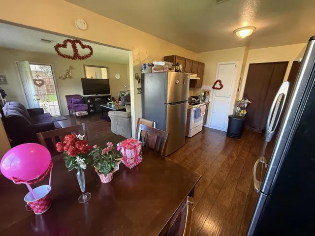 Dining space with dark wood-type flooring