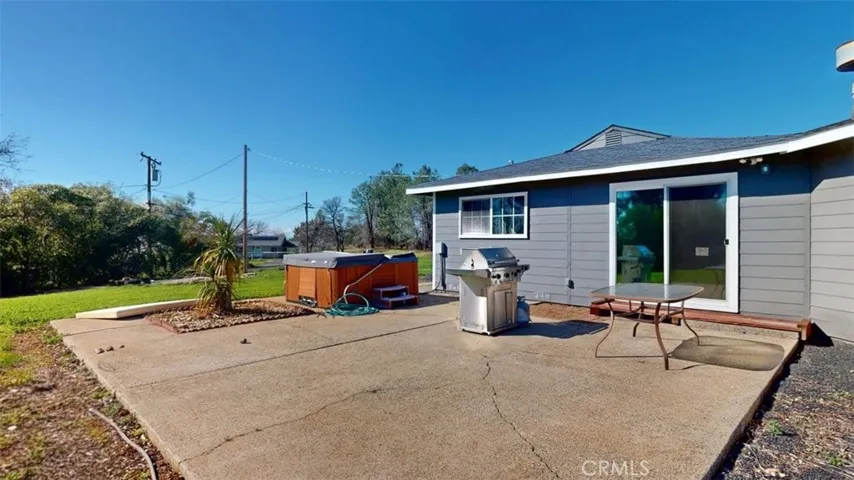 Another view of back of home and cement patio