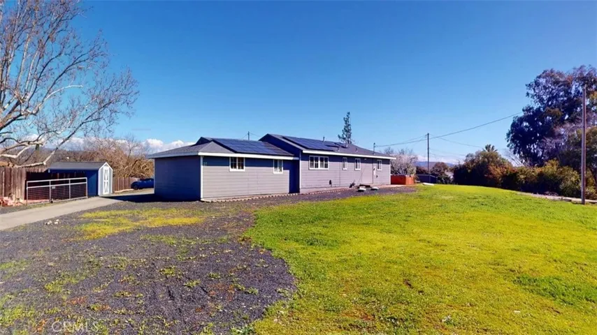 Gravel leading to RV parking and driveway to the left