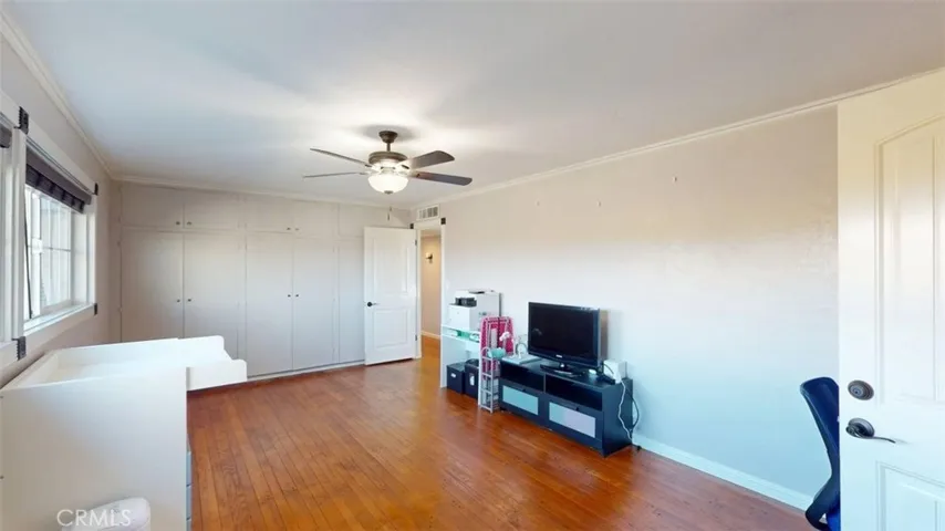 Standing at doorway of laundry room entering back into bedroom 2 with large wall closet.