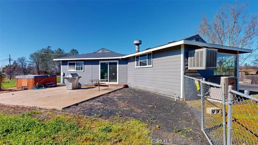 Back of home with sliding glass doors leading into dining area