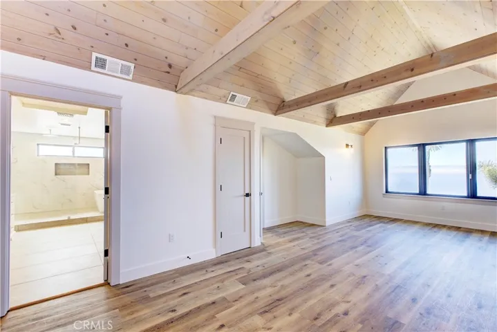 another view of the primary suite and entry to bathroom.