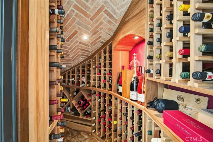 Refrigerated Wine Cellar with reclaimed Tuscan tile and custom redwood racks