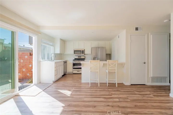SUNNY FAMILY - KITCHEN- DINING AREA   OVERLOOKS THE PRIVATE PATIO /Garage with Laundry area