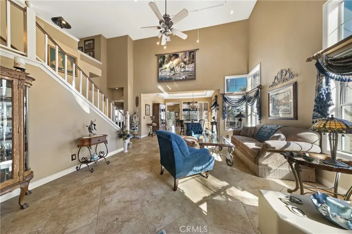 Your view when you enter is so impressive of a large open space with volume ceilings.  Note the beautiful tile flooring and wide baseboards.