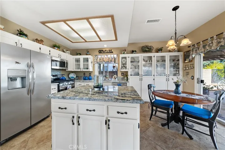 Your upgraded kitchen with stunning granite, glass front cabinets and an island.